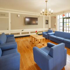 A large lounge in EEC with couches, chairs, and a tv mounted to the wall.