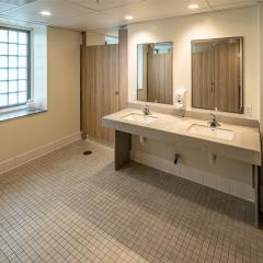 Two sinks, countertops, and two mirrors. 