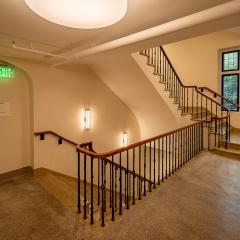 A winding stairwell and a hallway.