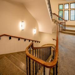 A winding stairwell and a hallway.