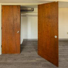 two closets with dark wood doors.