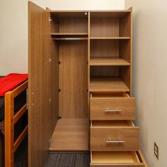 An open dresser showing drawers and space to hang clothes