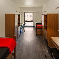 Double occupancy room with two beds, desks, and dressers