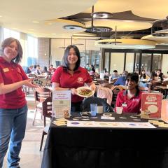 People wearing red Cornell shirts at an info table