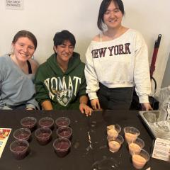People behind an info table with food samples