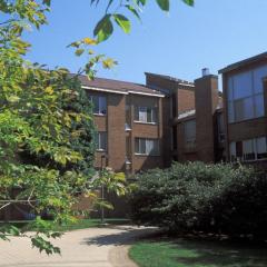 Exterior of JAM - a brick building with green trees