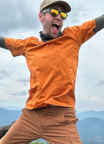 guy in sunglasses and orange shirt