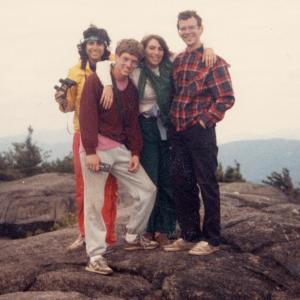 Four students stand together on a rock during their Wilderness Reflections/Outdoor Odyssey trip
