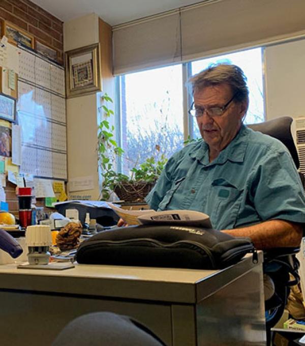Lou Farino sitting at his desk