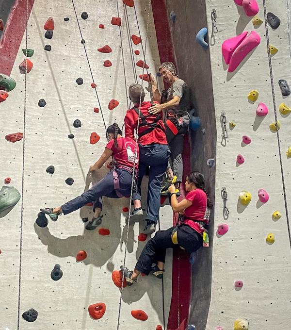 Students on the indoor adaptive ropes course