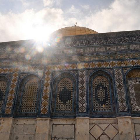 A Mosque with sunlight glinting over it