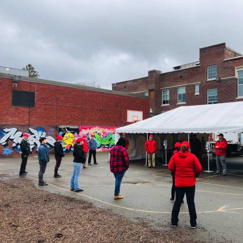 Staff around a tent prepared to hand out food