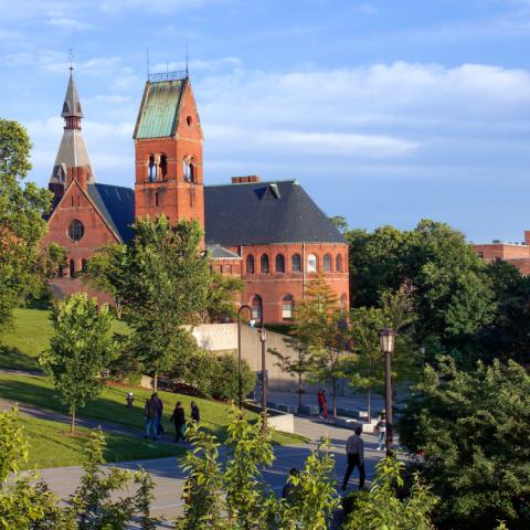 Exterior of Barnes Hall with people walking on Ho Plaza in the foreground