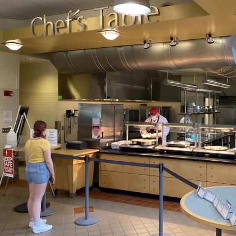 A student at a dining room serving line