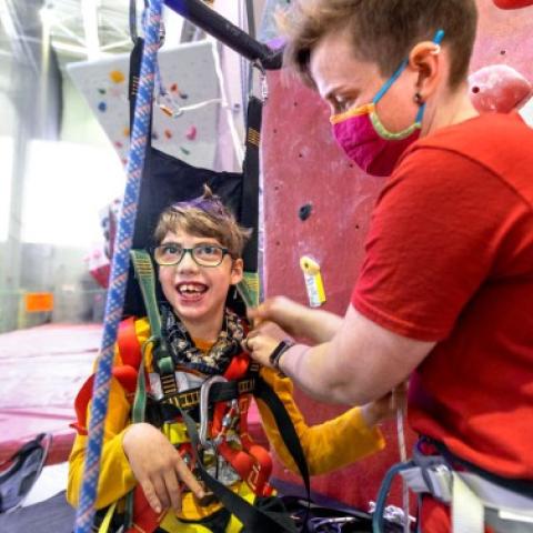 Participants prepare for an adaptive climbing program at Lindseth Climbing Wall