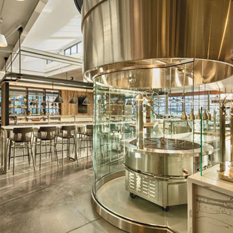 The Morrison Dining plancha grill station, featuring a circular grill behind glass