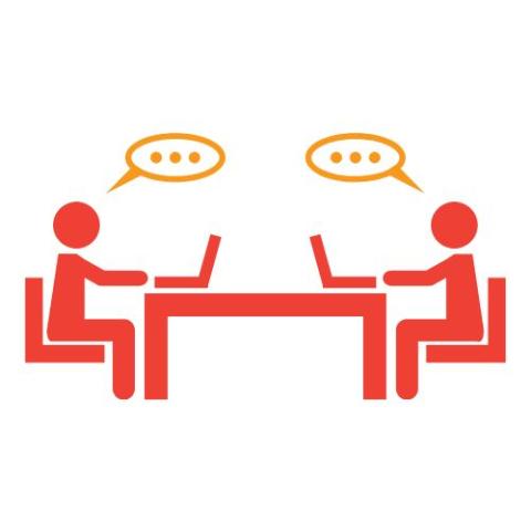 Image of two people sitting across the table from one another, looking at laptops, with speech bubbles overhead.