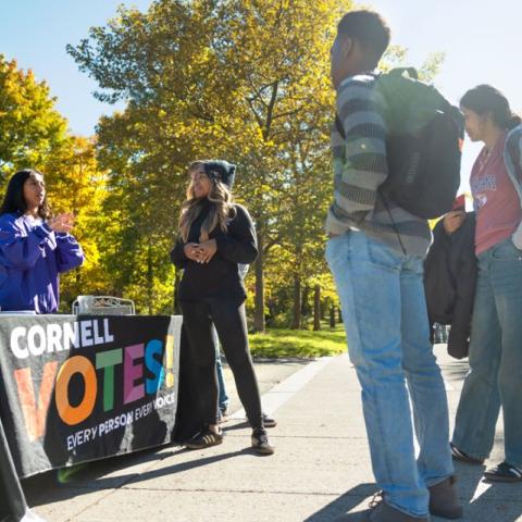 Students from the Cornell Policy Group, a nonpartisan student organization, help others register to vote on Ho Plaza.